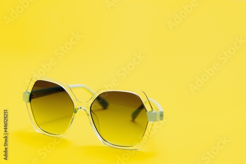 yellow sunglasses on yellow background