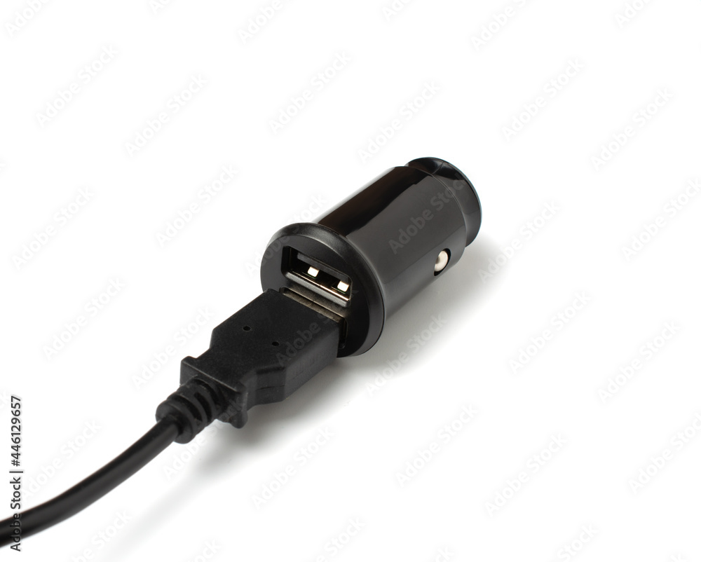 USB wire and black car charger with two USB ports, multifunctional cigarette lighter adapter plug. white background. copy space. USB wire and black car charger with two USB ports, multifunctional cigarette lighter adapter plug. white background. copy space.