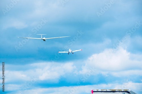 Propeller plane towing glider in sky, at Harris Hill, Elmira, New York - known as the “Soaring Capital of America” 
