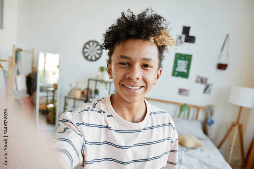 POV of mixed-race teenage boy smiling at camera during video chat or live  stream in cozy room, copy space Stock Photo | Adobe Stock