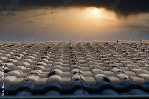 Grey terracotta roof tiles in a line on a roof
