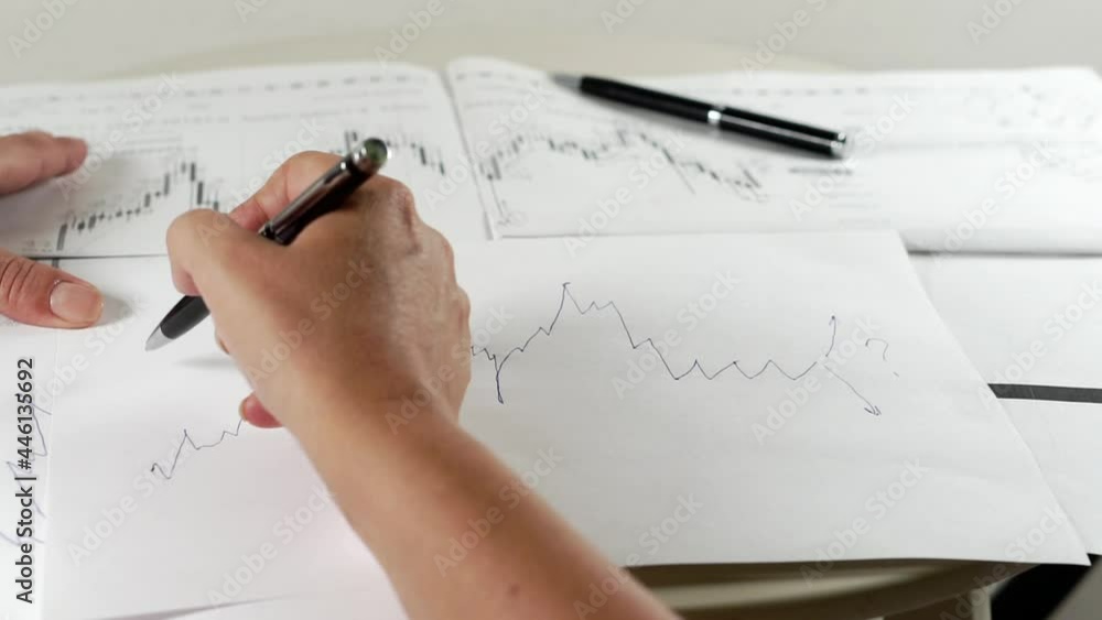 Bitcoin Stock Chart Analysis: A broker, trader or investor is analyzing a cryptocurrency stock chart. Bitcoin Stock Chart Analysis: A broker, trader or investor is analyzing a cryptocurrency stock chart.