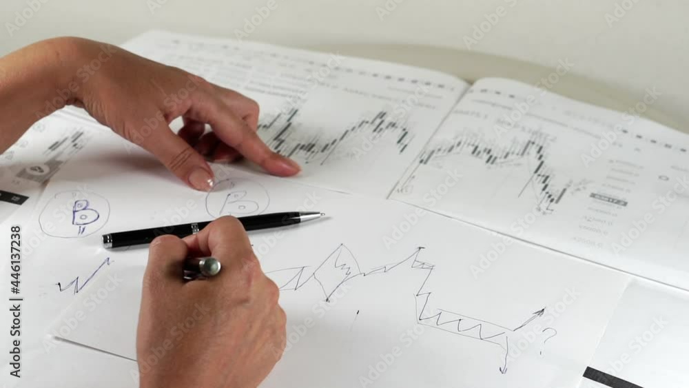 Bitcoin Stock Chart Analysis: A broker, trader or investor is analyzing a cryptocurrency stock chart. Bitcoin Stock Chart Analysis: A broker, trader or investor is analyzing a cryptocurrency stock chart.