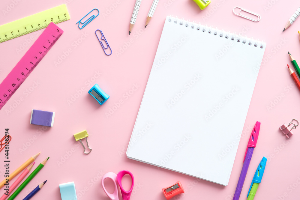 Flat lay school supplies and paper notebook on pink background. Back to school concept. Flat lay school supplies and paper notebook on pink background. Back to school concept.