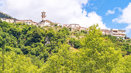 low angle view of the picturesque old town Posta Fibreno on the hill, surrounded by the dense vegetation of the nature reserve, amid the Apennine mountains of south-east Lazio region photo