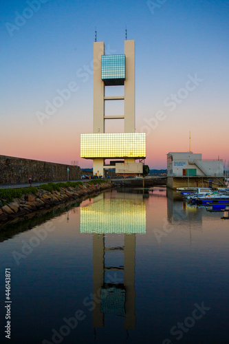 Maritime watchtower of A Coruna reflected in the water at sunset