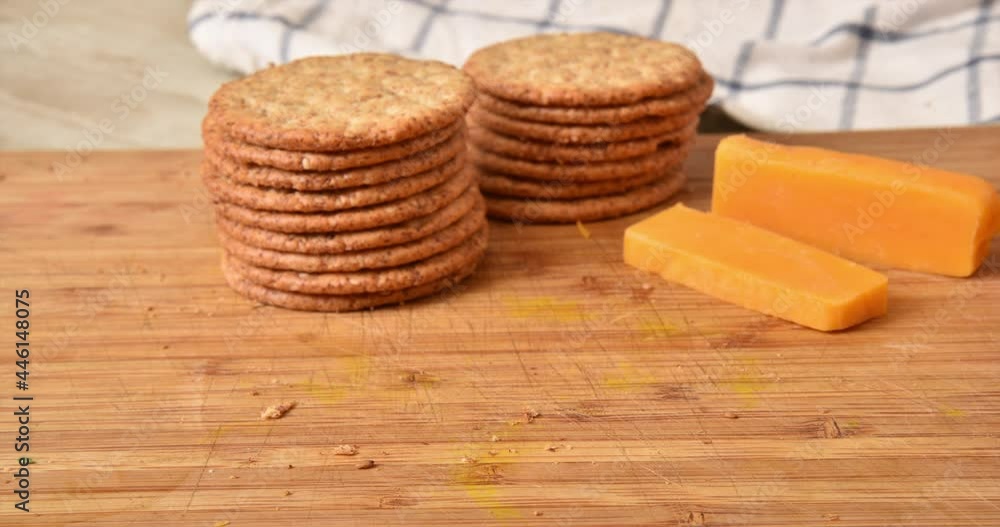 Crackers and cheddar cheese vanishing from a cutting board stop motion animation Crackers and cheddar cheese vanishing from a cutting board stop motion animation
