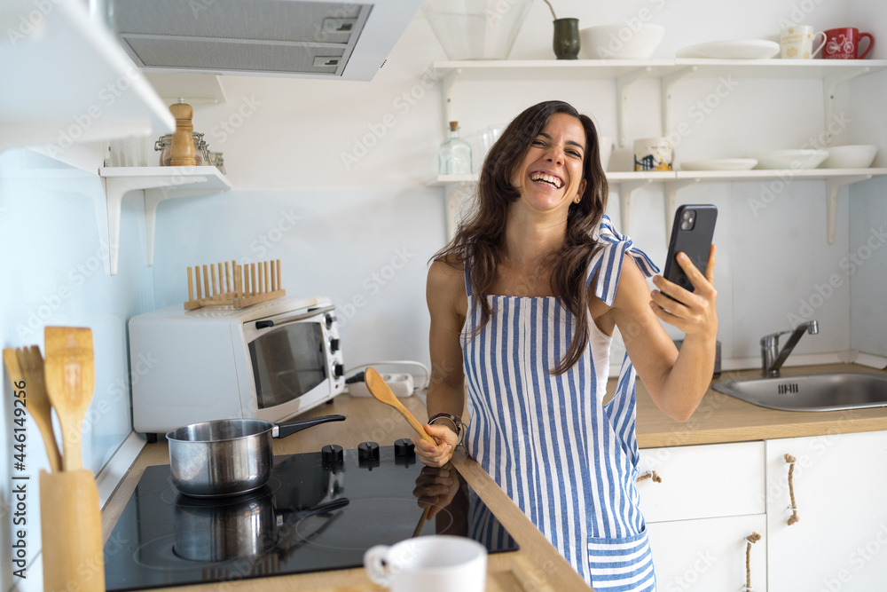 carefree young female at home having a video conference carefree young female at home having a video conference
