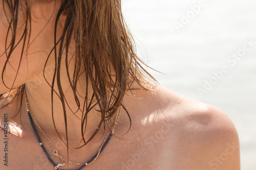 Woman s hair on the beach. Wet hair close up image. Hair damage due to salty ocean water and sun  summertime hair care concept. 