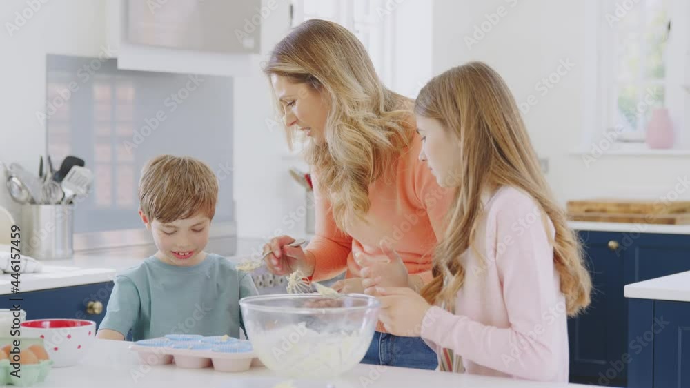 Mother Putting Cake Mixture On Son's Nose In Kitchen As They Have Fun Baking Cakes Together Mother Putting Cake Mixture On Son's Nose In Kitchen As They Have Fun Baking Cakes Together