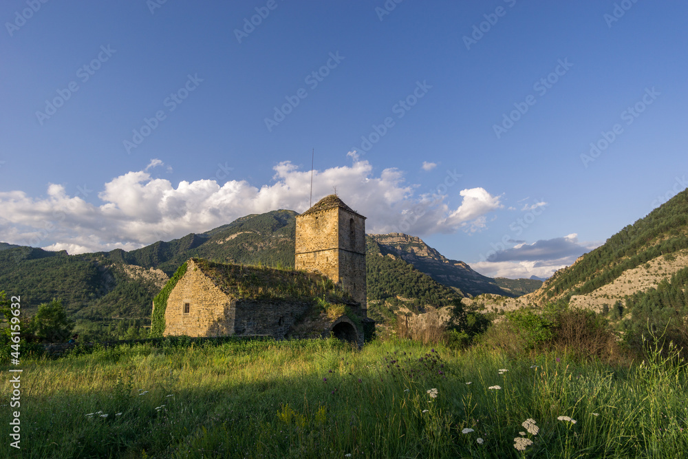 Abandoned church in ghost village janovas in pyrenees landscape at golden hour, Spain