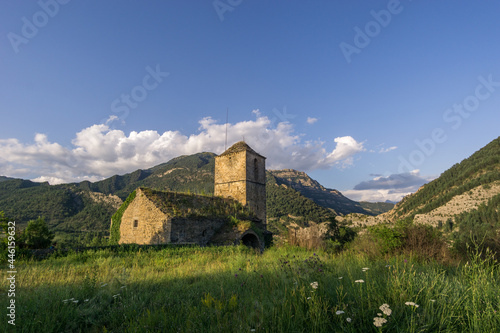 Abandoned church in ghost village janovas in pyrenees landscape at golden hour, Spain