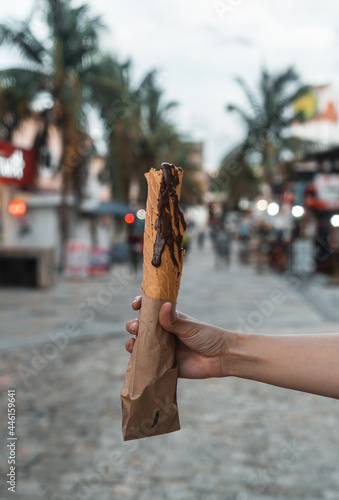 woman's hand holding typical mexican dessert with chocolate - typical foods - marquesitas