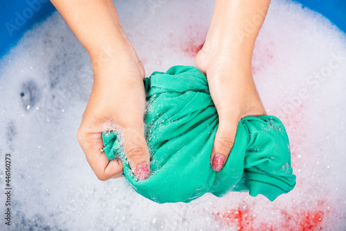 Принти на полотні Closeup young Asian woman use hands washing color clothes in basin