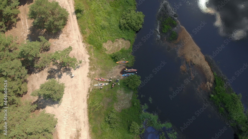 Aerial drone view of group kayak in river. Rafting. Tourist base of kayaks and canoes, summer adventure kayak, rafting to canoe. Kayaking top view