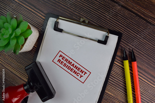 Red Handle Rubber Stamper and Permanent Residency text isolated on White Background. photo