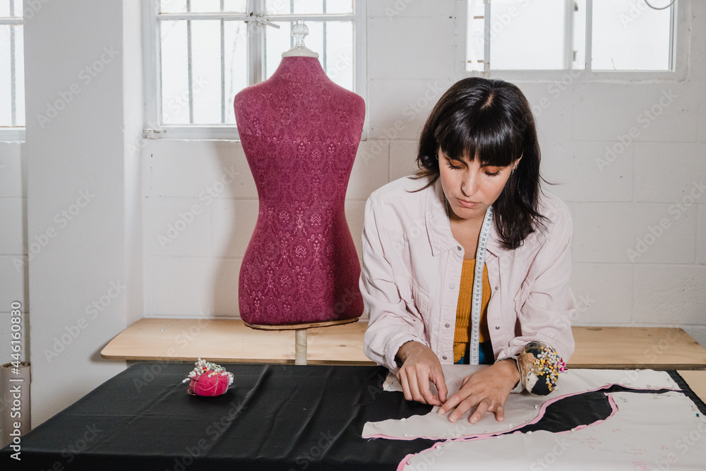 Hispanic woman fashion designer working in studio Hispanic woman fashion designer working in studio