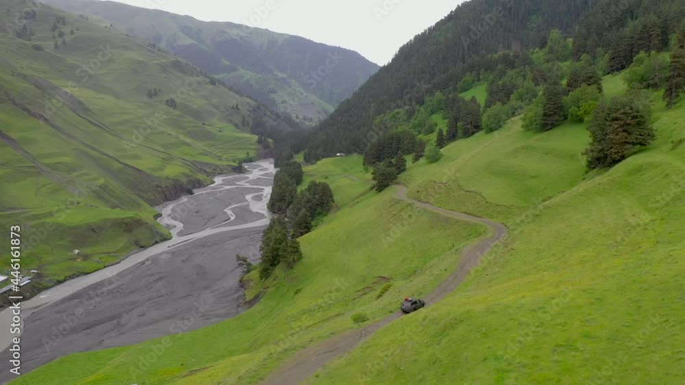Rotating drone shot of vehicle driving on the Abano Pass, the road to Tusheti Georgia Rotating drone shot of vehicle driving on the Abano Pass, the road to Tusheti Georgia
