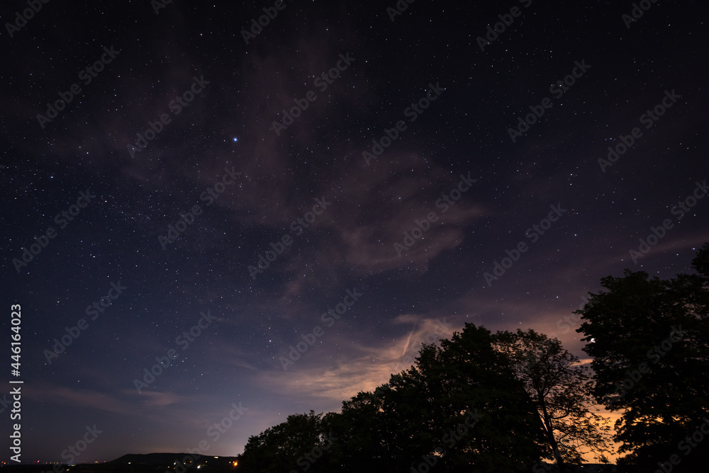 Naklejka premium clouds over the city lights