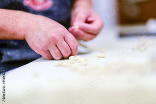 Chef preparing Pisarei traditional italian pasta from Piacemza, Italy made of breadcumbs, flour, water and salt. photo