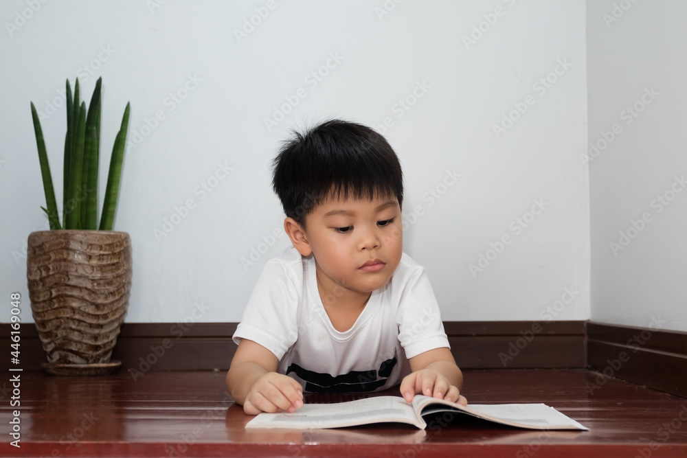 A Thai student reading and reviewing lessons at his home A Thai student reading and reviewing lessons at his home