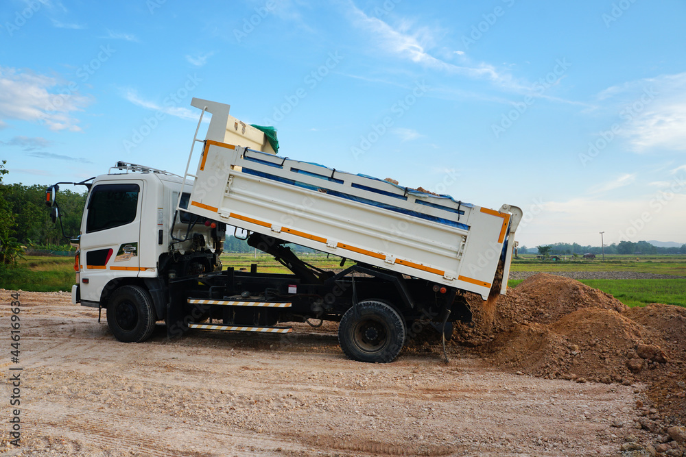 Dump truck unloading process on construction site. Dump truck unloading process on construction site.