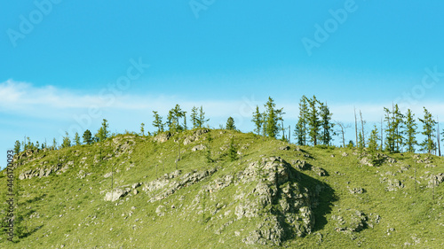 Horizontal panorama with a green mountain overgrown with forest on a background of blue sky. Natural background with copy space.