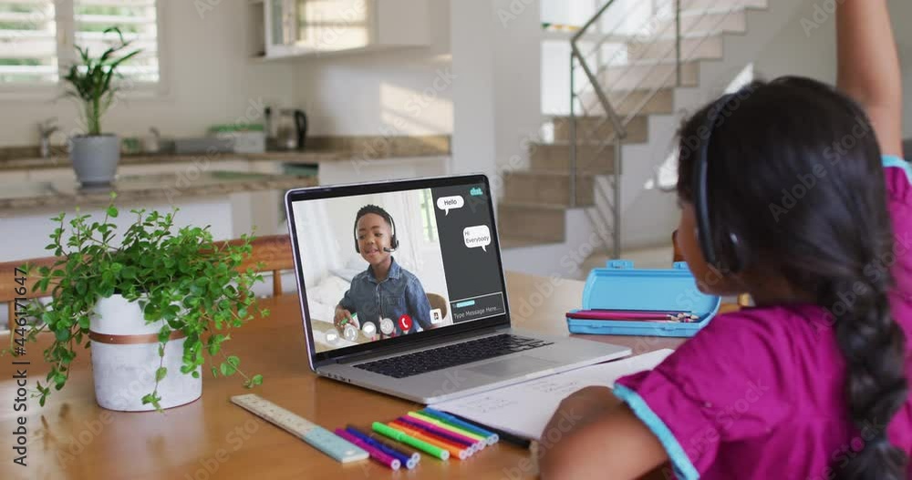 Schoolgirl using laptop for online lesson at home, with her school friend and web chat on screen Schoolgirl using laptop for online lesson at home, with her school friend and web chat on screen