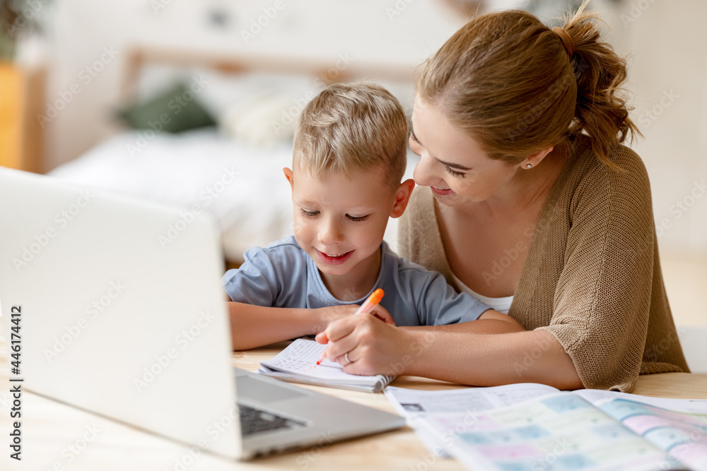 Happy mother supporting son during online studies Happy mother supporting son during online studies