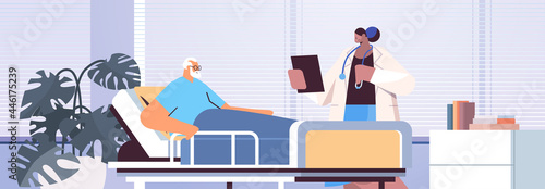 nurse taking care of sick senior man patient lying in hospital bed care service concept horizontal