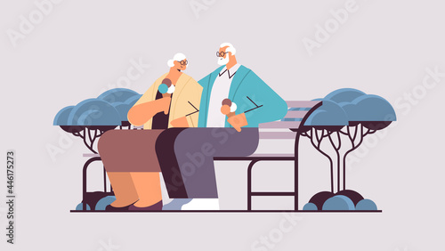 senior couple sitting on bench and eating ice cream happy grandparents spending time together in park