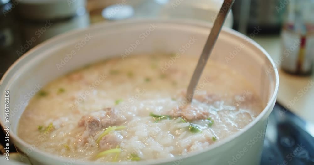 close up cooking stirring and holding Thai style food hot soft boiled rice with Pork Ribs at the kitchen, breakfast healthy food concept close up cooking stirring and holding Thai style food hot soft boiled rice with Pork Ribs at the kitchen, breakfast healthy food concept