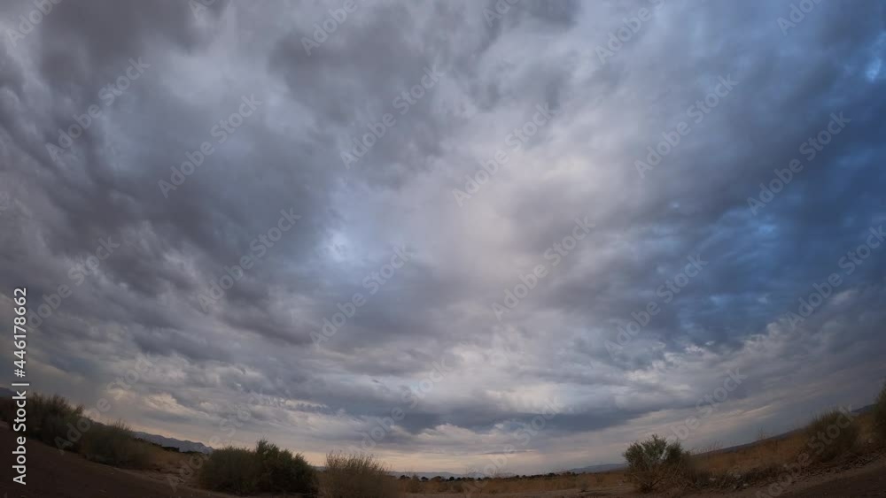Dark storm clouds produce a rare cloudburst over the arid Mojave Desert basin - static wide angle time lapse Dark storm clouds produce a rare cloudburst over the arid Mojave Desert basin - static wide angle time lapse