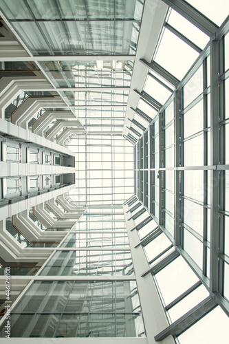 Low angle view of high modern building with big windows and glass ceiling