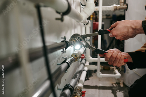 Hands of technician or plumber repairing broken pipes in toilet