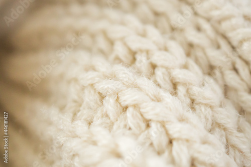 closeup beige knitted woolen fabric background