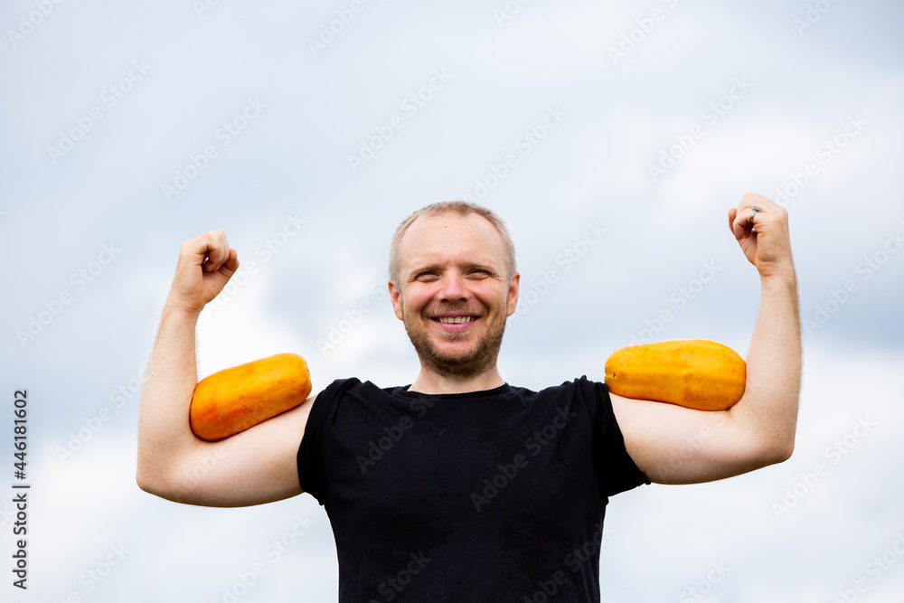 Caucasian hipster eat two papaya outdoors, vegetarian Caucasian hipster eat two papaya outdoors, vegetarian