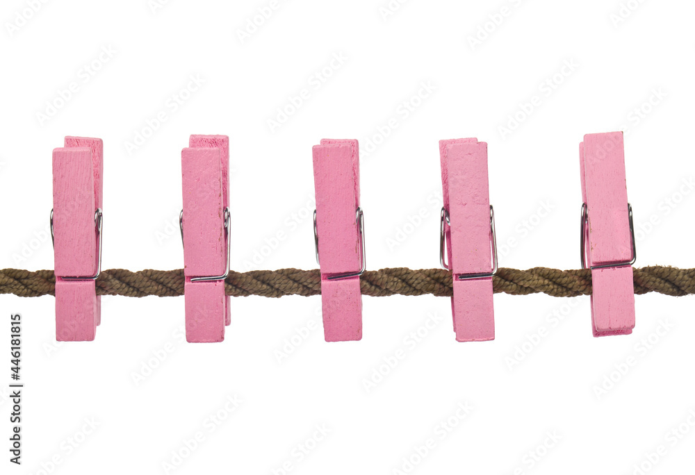 Pink clothespins on a rope isolated on white background. Pink clothespins on a rope isolated on white background.