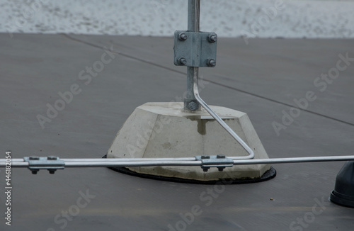 Konstfotografi A lightning conductor is used to protect buildings from lightning that can damage a house or its electrical equipment is routed to the highest points of a green garden roof