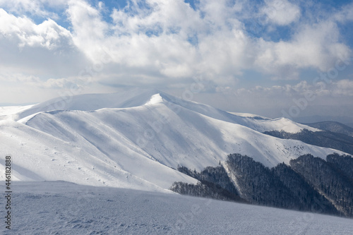 Winter Carpathian mountains. Borzhava mountain range. landscapes of winter mountains. Snow drifts are treated by the wind, against the background of winter mountains.