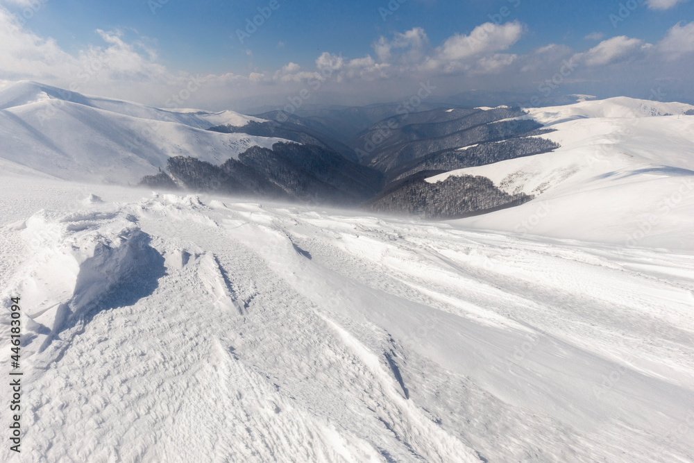 Winter Carpathian mountains. Borzhava mountain range. landscapes of winter mountains. Snow drifts are treated by the wind, against the background of winter mountains.