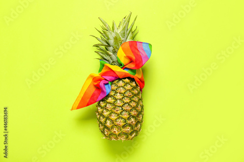 Fresh pineapple in kerchief on color background
