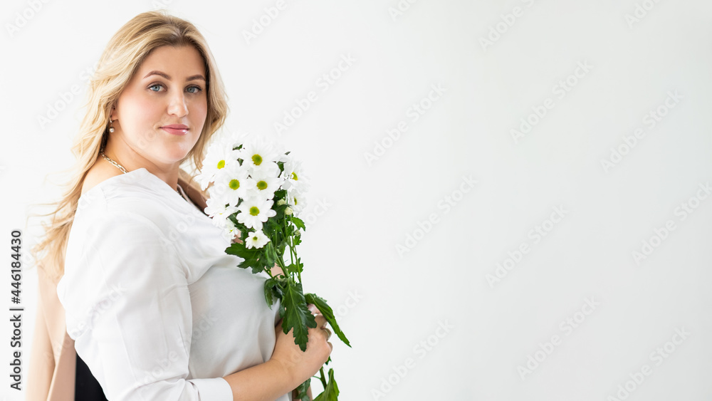 Online dating. Woman day. Body positive. Festive anniversary greeting. Confident overweight obese lady with white flowers bouquet isolated on light copy space background. Online dating. Woman day. Body positive. Festive anniversary greeting. Confident overweight obese lady with white flowers bouquet isolated on light copy space background.