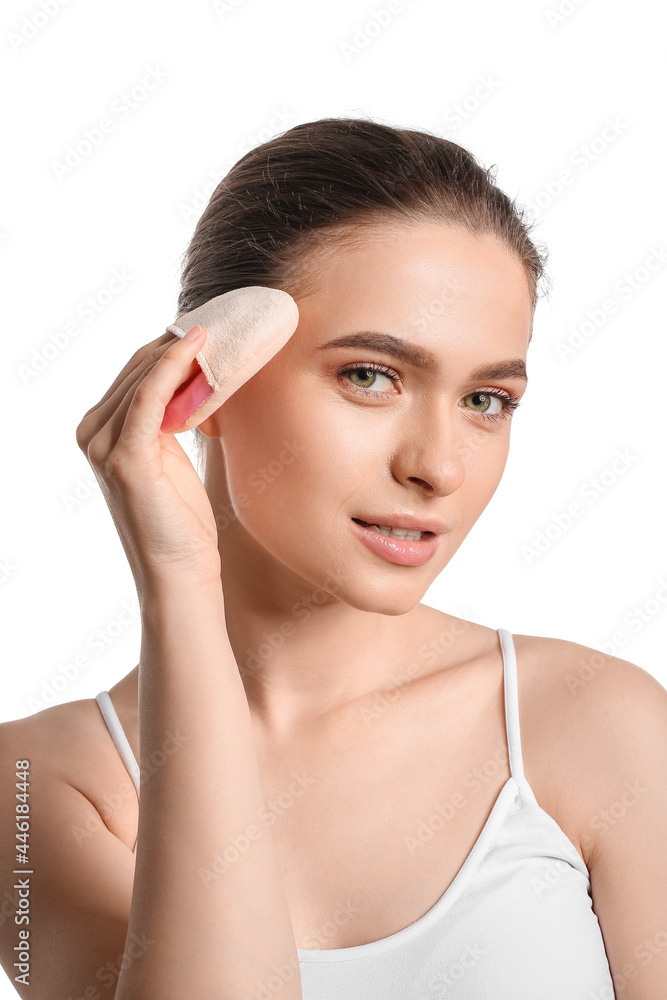 Beautiful young woman with makeup sponge on white background Beautiful young woman with makeup sponge on white background