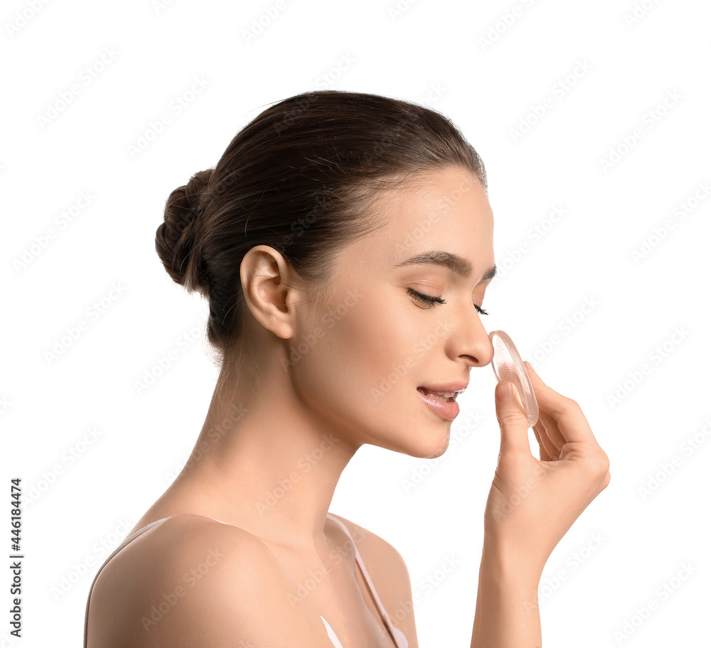 Beautiful young woman with makeup sponge on white background Beautiful young woman with makeup sponge on white background