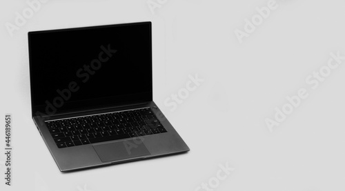 laptop on a grey background with a copy space