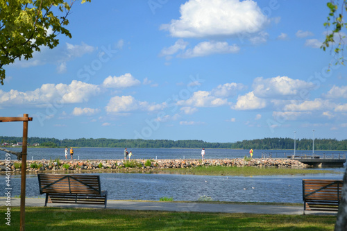 Lake promenade in sunny summer day. Beautiful landscape. Horizontal view. Wallpaper. Travelling.   