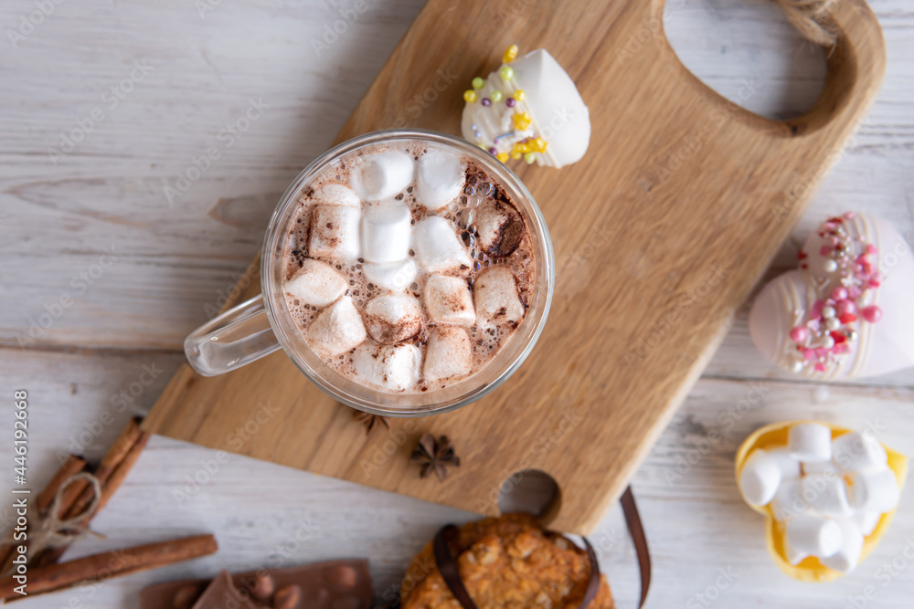 Hot drink with marshmallows on a wooden table. Hot drink with marshmallows on a wooden table.