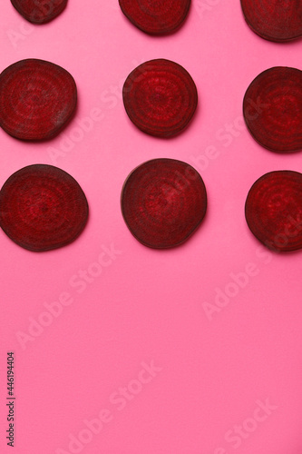 Chopped ripe red beet on pink background