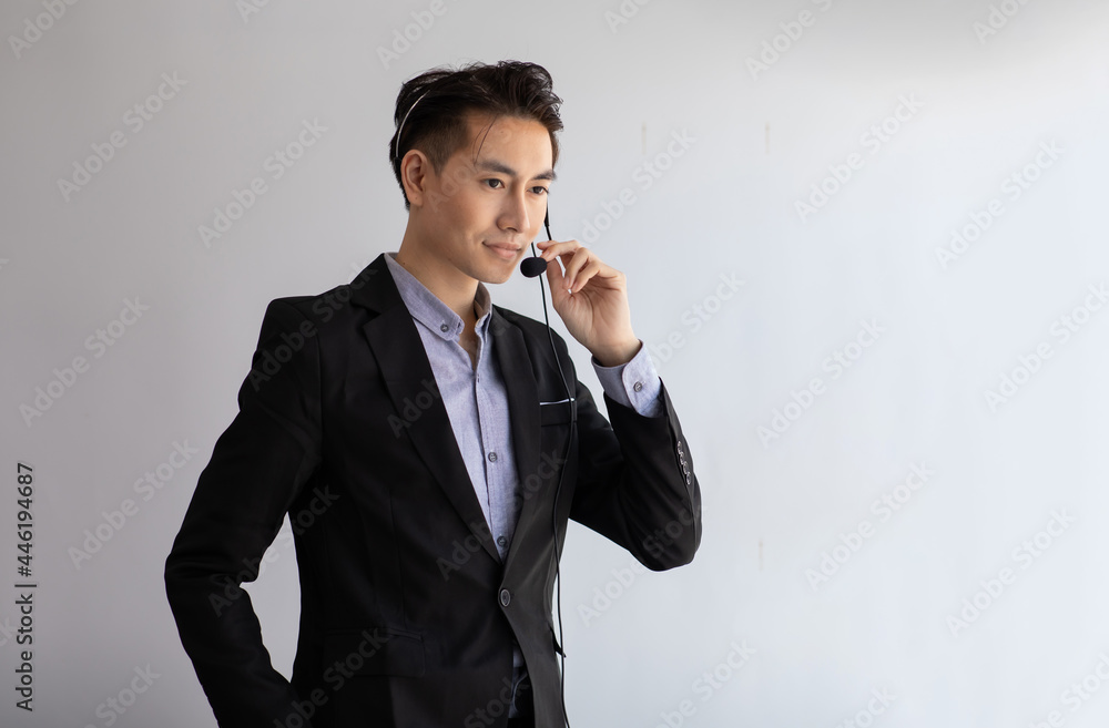 Portrait business Asian man callcenter manager worker in headset working with desktop computer at telemarketing customer service agents. Portrait business Asian man callcenter manager worker in headset working with desktop computer at telemarketing customer service agents.